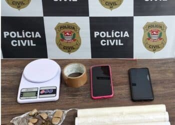 Maconha e materiais apreendidos em caso de tráfico de drogas e associação para o tráfico em Votuporanga #PraCegoVer imagem mostra porções de maconha embaladas, balança de precisão, plástico filme, fita adesiva e celulares sobre mesa