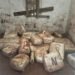 300 kg de drogas em construção abandonada em Serra Negra #PraCegoVer: fardos de drogas apreendidos organizados em área rural após ação policial com apoio de drone.