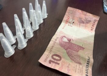 homem preso com cocaína na operação Impacto em Cosmópolis #PraCegoVer: imagem mostra pinos de cocaína em fileira dupla contendo 11 pinos e uma nota de R$10 encima de uma mesa na delegacia