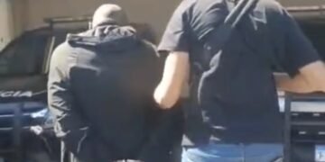 latrocinio esclarecido em Santa Maria da Serra #PraCegoVer imagem mostra policial civil com arma longa, retirando suspeito de dentro da viatura descaracterizada que está sobre investigação da Polícia Civil em caso de roubo seguido de morte com prisão de suspeito