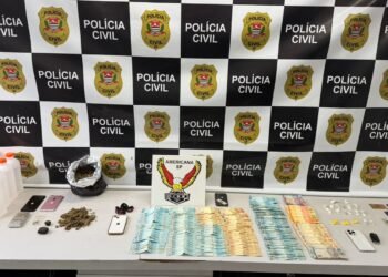 operação Spazio contra disque-entrega de drogas #PraCegoVer imagem mostra mesa com dinheiro em espécie, celulares, drogas, cartões bancários, galões de lança-perfume, balança de precisão e outros objetos apreendidos pela Polícia Civil em Americana