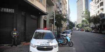 Operação Resgate identificou 4,8 mil frequentadores da Cracolândia com uso de tecnologia em São Paulo #PraCegoVer: viatura da Polícia Militar estacionada em rua do centro de São Paulo durante operação de segurança na antiga região da Cracolândia, com policial realizando patrulhamento em área urbana cercada por prédios.