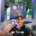 cabo da PMESP ganha bronze no tiro em mundial policial. #PraCegoVer Cabo da PMESP segurando arma em competição